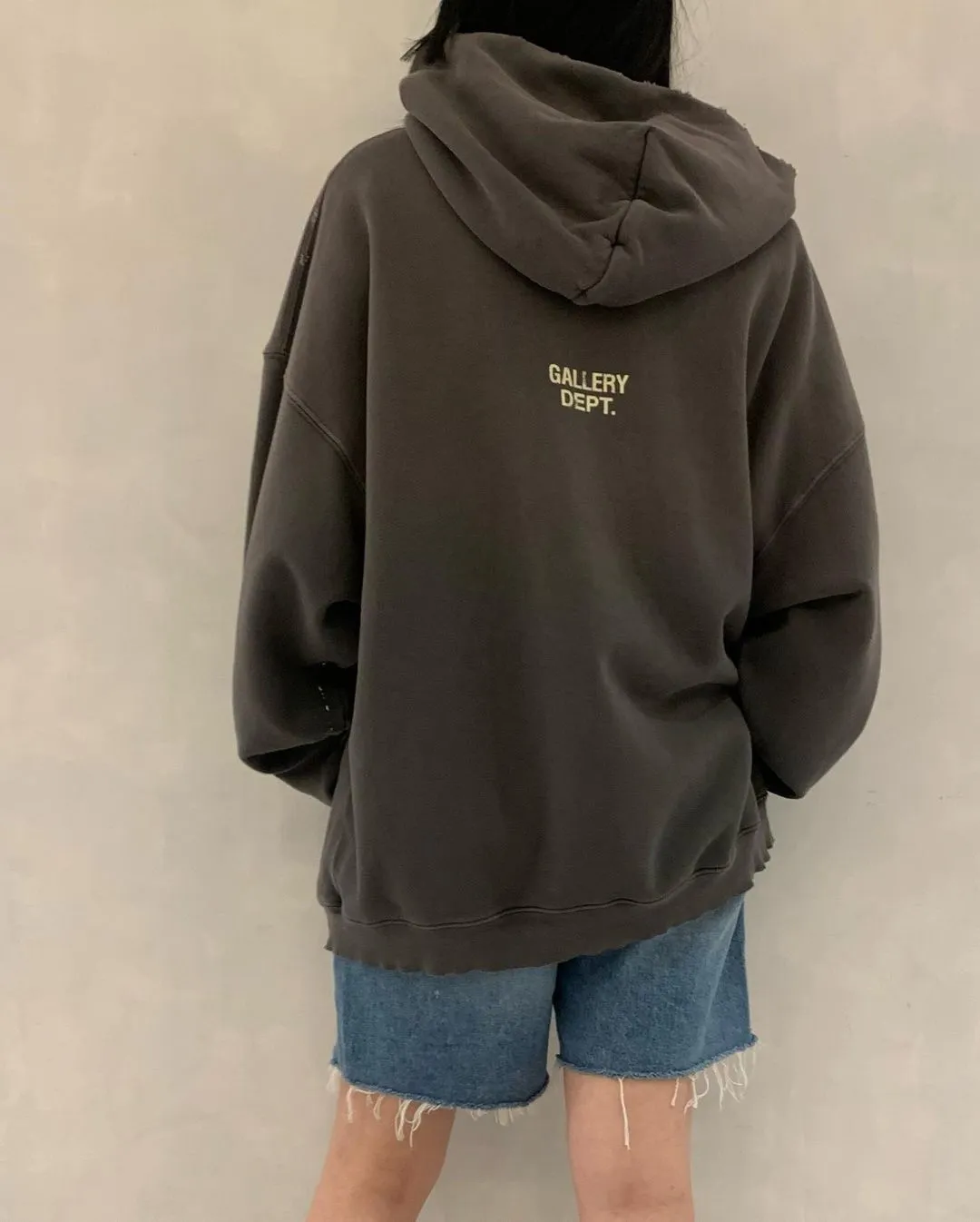 GALLERY DEPT. 90'S RECYCLE HOODIE WASHED BLACK 90'S washed hoodie with distressed eco-friendly slogans. Washed black S-XL. Ready-made garments are washed and dyed again. Multiple spots throughout the body are spray-faded. The ribs are cut and worn.